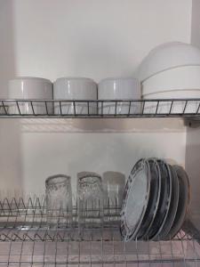 a shelf with glasses and plates in a kitchen at ЖК Куралай in Qyzylorda