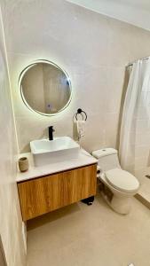 a bathroom with a sink and a toilet and a mirror at Hotel Sunset Mar in Lima