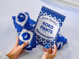 a person holding up a box of koko pens at Kokotel Bangkok Surawong in Bangkok