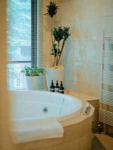 a bathroom with a tub with potted plants on it at Hotel La Neige in Hakuba +79 photos