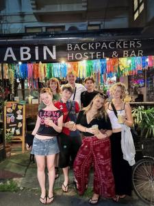 a group of people standing in front of a store at The Cabin Backpackers Hostel & Bar in Chiang Mai