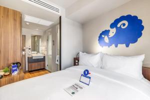 a bedroom with a bed with a blue cloud on the wall at Kokotel Bangkok Surawong in Bangkok +46 photos