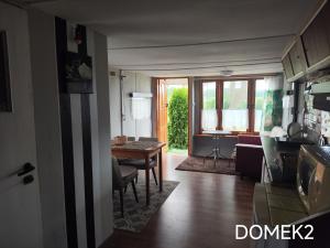 a kitchen and living room with a table and a dining room at Gospodarstwo Agroturystyczne RYBAKÓWKA in Warlubie +25 photos