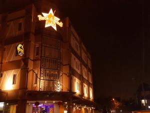 a building with a star on top of it at night at Rock & Roll Hotel Klang in Klang