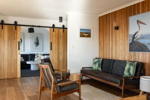 a living room with a couch and chairs in it at Drift - Watch the world go by in Scamander