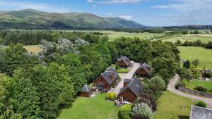 an aerial view of a home with a yard and trees at La Fortuna Lodges in Stirling