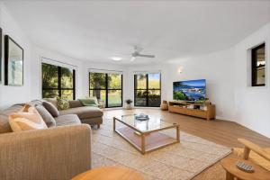a living room with a couch and a table at Wyuna Drive 53 in Noosaville