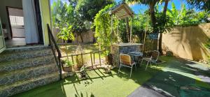 a backyard with a grill and a table and chairs at The nest in Goodlands