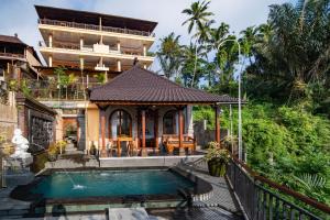 a house with a swimming pool in front of a building at Campuhan Sebatu Resort in Tegalalang