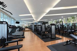 a gym with lots of treadmills and machines at Sunlake Waterfront Resort & Convention in Jakarta