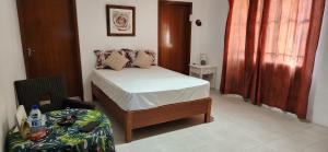 a small bedroom with a bed and a table at The nest in Goodlands