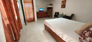 a bedroom with a bed and a television in it at The nest in Goodlands