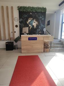 a room with a desk and a large wall at Tut Hotel in Antalya