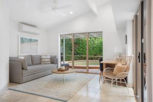 a living room with a couch and a table at Witta Circle 24 in Noosa Heads