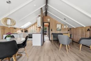 a kitchen and dining room with a table and chairs at Mtb Beach Peace Holiday By The Dunes in Fjerritslev