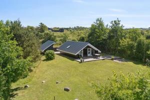 an aerial view of a small house with a yard at Mtb Beach Peace Holiday By The Dunes in Fjerritslev