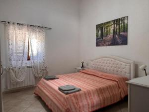 a bedroom with a bed with a orange bedspread at CASALE ANTICO SOBBORGO in Vitorchiano +44 photos