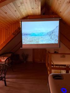 a large screen in a room with a lecture hall at Koliba Brezova šuma in Čović Polje