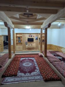a large room with a large rug on the floor at Passu Didargah Resort in Pasu