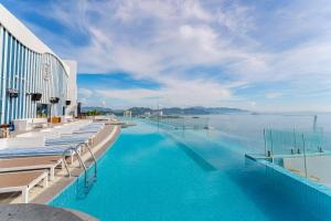 a swimming pool with a view of the water at Crystal Bay Premier Suites in Nha Trang