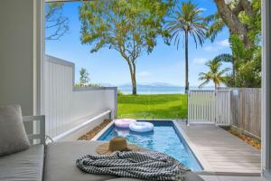 a patio with a swimming pool and a couch at Rock Salt Villa 2 in Picnic Bay +3 photos