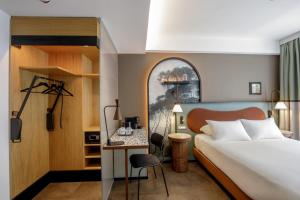 a hotel room with a bed and a desk at The Spring House Hotel Rome Vatican, Tapestry Collection Hilton in Rome