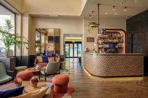 a lobby of a hotel with a bar at The Spring House Hotel Rome Vatican, Tapestry Collection Hilton in Rome
