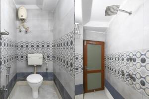 a bathroom with a toilet and a sink at Hotel O Calcutta University Formerly Hamza International in Kolkata +23 photos