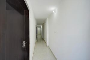 ein leerer Flur mit einer Tür und einer Flurlänge in der Unterkunft Super Collection O Taramandal Road Gorakhpur Formerly NS Hotel in Gorakhpur