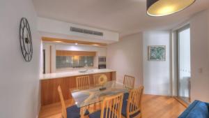 a kitchen and dining room with a table and chairs at Maggies Beachfront Apartment 11 in Horseshoe Bay