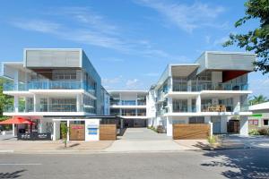 an apartment building with balconies on a street at Maggies Beachfront Apartment 11 in Horseshoe Bay