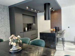 a kitchen and dining room with a table and chairs at Villa Calypso, private pool with heating and salt water in Lozenets