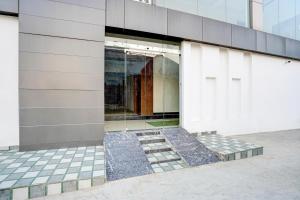 a facade of a building with a glass door at Super Collection O Friends Colony Lucknow Formerly The Suite in Lucknow