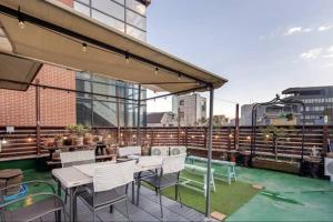 a patio with a table and chairs on a building at Young Stay in Seoul