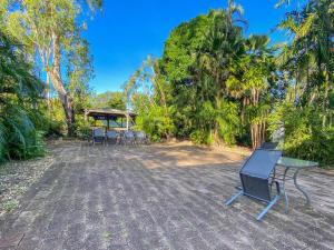 a patio with a table and chairs and trees at The Captains Manor on Cook 8 in Arcadia +3 photos