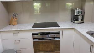 a small kitchen with a stove and a sink at Magnetic Reef 7 in Arcadia +10 photos