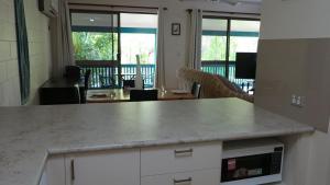 a kitchen with a counter top and a living room at Magnetic Reef 7 in Arcadia