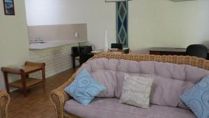 a living room with a couch with pillows on it at Magnetic Reef 7 in Arcadia