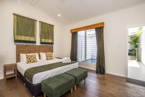 a bedroom with a large bed and a large window at Reflections Amber Villa 2 in Picnic Bay