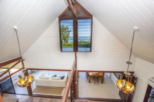 an attic room with a couch and a window at On the Beach in Horseshoe Bay