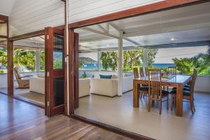 a dining room and living room with a table and chairs at On the Beach in Horseshoe Bay +14 photos