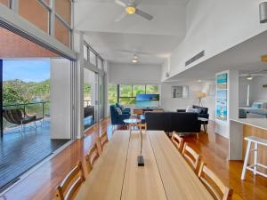a dining room and living room with a table and chairs at Maggies Beachfront Apartment 12 in Horseshoe Bay +30 photos
