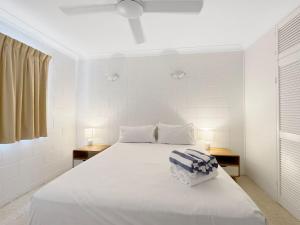 a bedroom with a large white bed with two tables at Arcadia Palms 1 in Arcadia