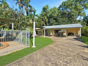 a house with a fence and a playground at Arcadia Palms 1 in Arcadia +3 photos