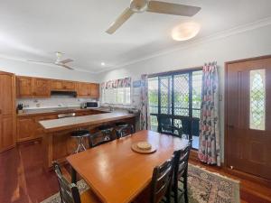 a kitchen with a wooden table and a dining room at Arcadia Gardens in Arcadia