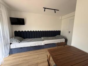 a bedroom with a bed and a tv on a wall at Pokoje U rybaka in Stężyca