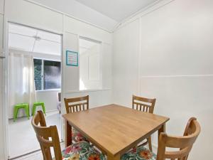 a dining room with a wooden table and chairs at The Barracks Arcadia 2 in Arcadia