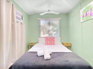 a bedroom with a bed with two towels on it at The Barracks Arcadia 2 in Arcadia