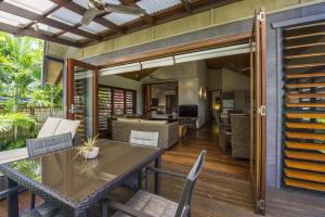 an outdoor dining area with a table and chairs at Pure Magnetic Villa 3 in Nelly Bay