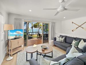 a living room with a blue couch and a table at Sails on Horseshoe Apartment 4 in Horseshoe Bay